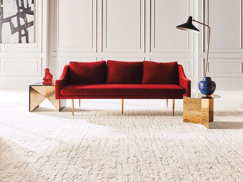 Living room with red couch on a beige nylon carpet floor from Direct Sales Floors in Danville, CA