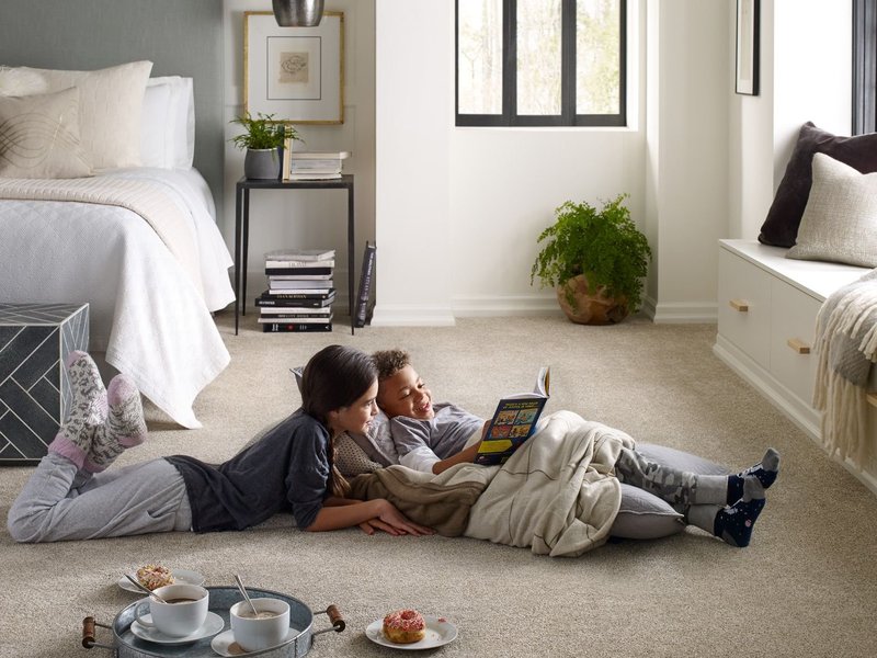 Kids reading on the beige carpet floor from Direct Sales Floors in Danville, CA